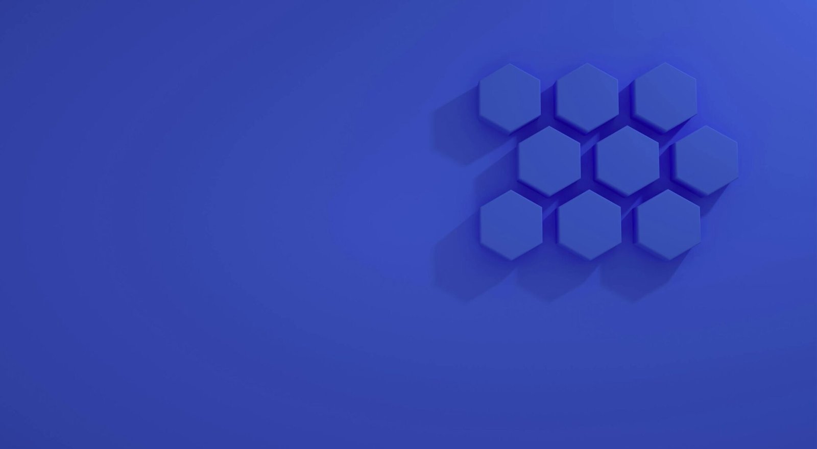 A minimalist abstract design featuring blue hexagons on a blue background.